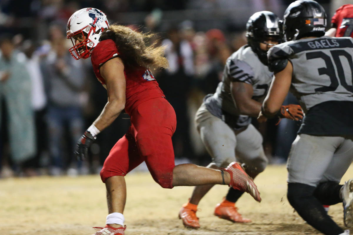 Liberty's Zyrus Fiaseu (30) rushes the ball for a touchdown to win in overtime as Bishop Gorman ...