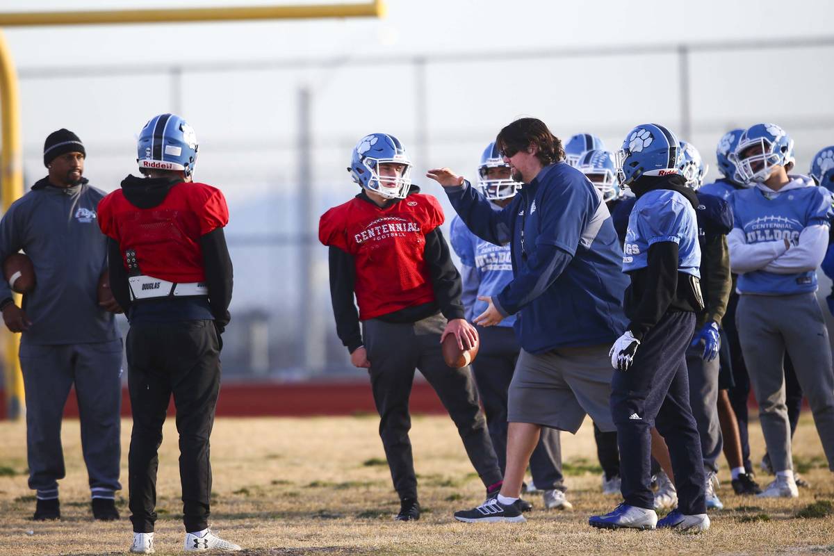 Centennial football coach Dustin Forshee, right, motions in front of quarterback Colton Tenney, ...