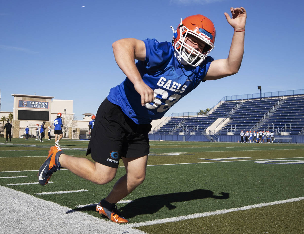 Football players work through defensive drills during practice at Bishop Gorman High School on ...