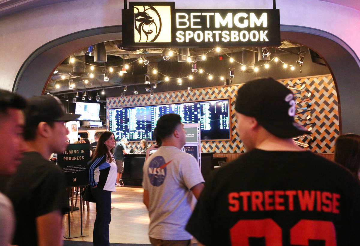 Gusts walk past the new sportsbook at Park MGM on Friday, March. 6, 2020, in Las Vegas. (Bizuay ...