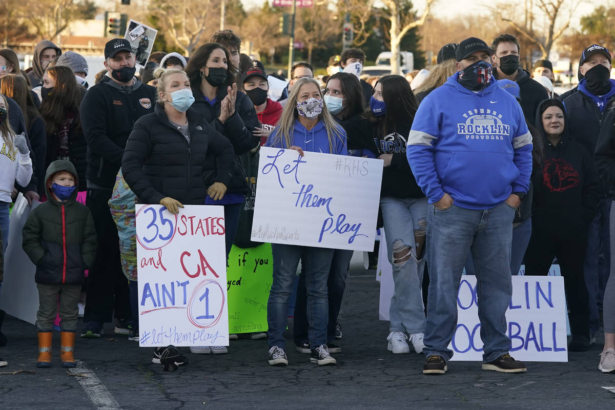 In this Jan. 29, 2021, file photo, people gather at a "Let Them Play Rally" in Citrus Heights ...