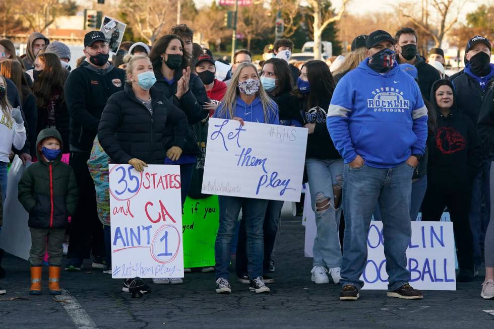 In this Jan. 29, 2021, file photo, people gather at a "Let Them Play Rally" in Citrus Heights ...