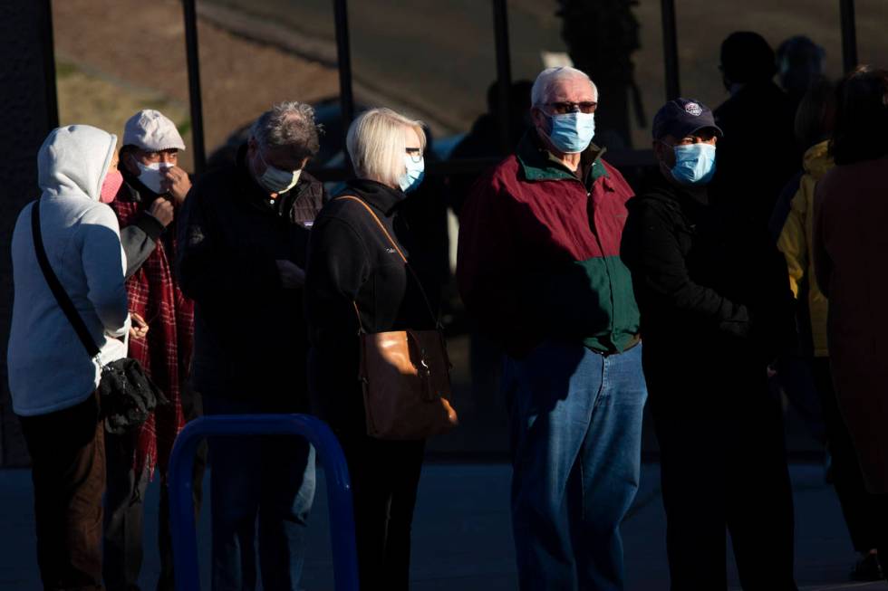 People wait in line for their COVID-19 vaccine at Cashman Field on Saturday, Feb. 20, 2021, in ...