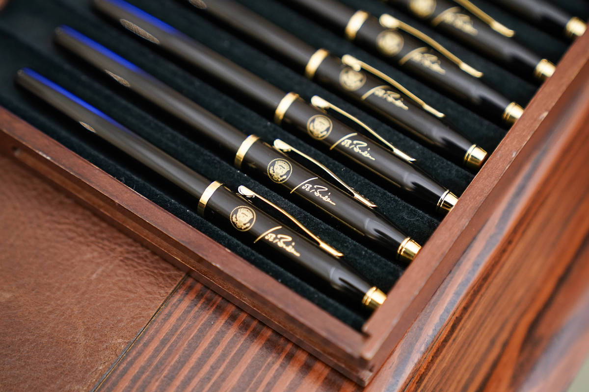 FILE - In this Jan. 21, 2021, file photo pens featuring President Joe Biden's signature and pre ...