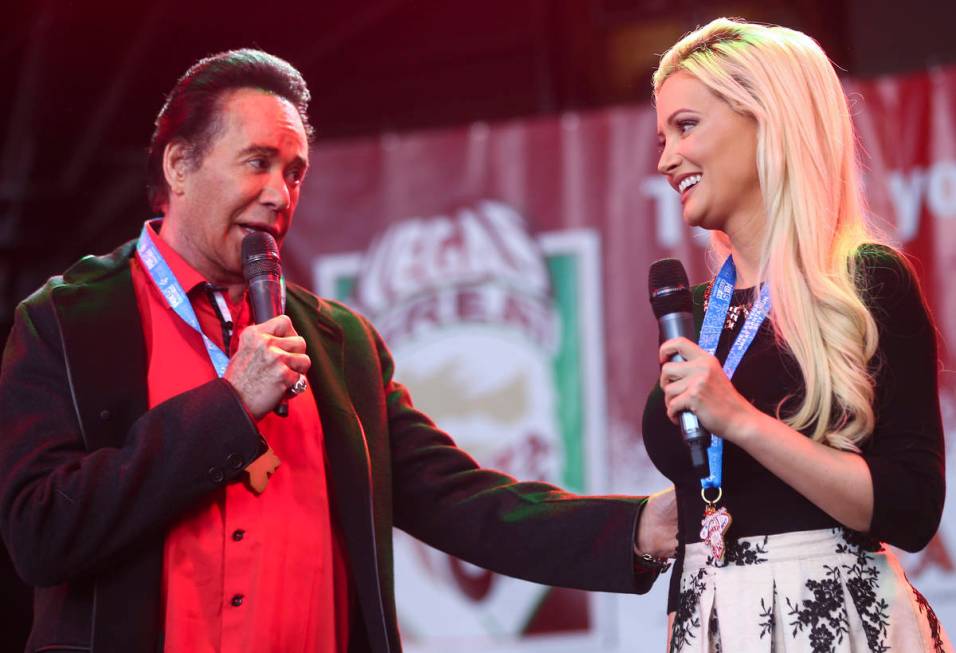 Wayne Newton and Holly Madison before the start of the Las Vegas Great Santa Run in downtown La ...