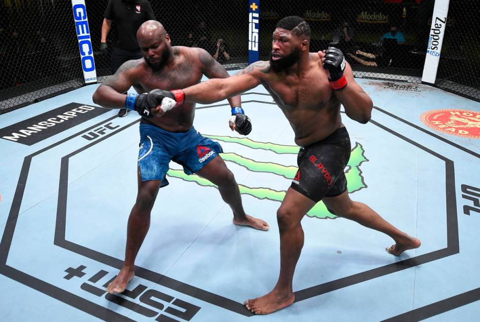 (R-L) Curtis Blaydes punches Derrick Lewis in a heavyweight bout during the UFC Fight Night eve ...