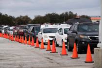 Hundreds of cars come through NRG Park to get food supplies during the Neighborhood Super Site ...