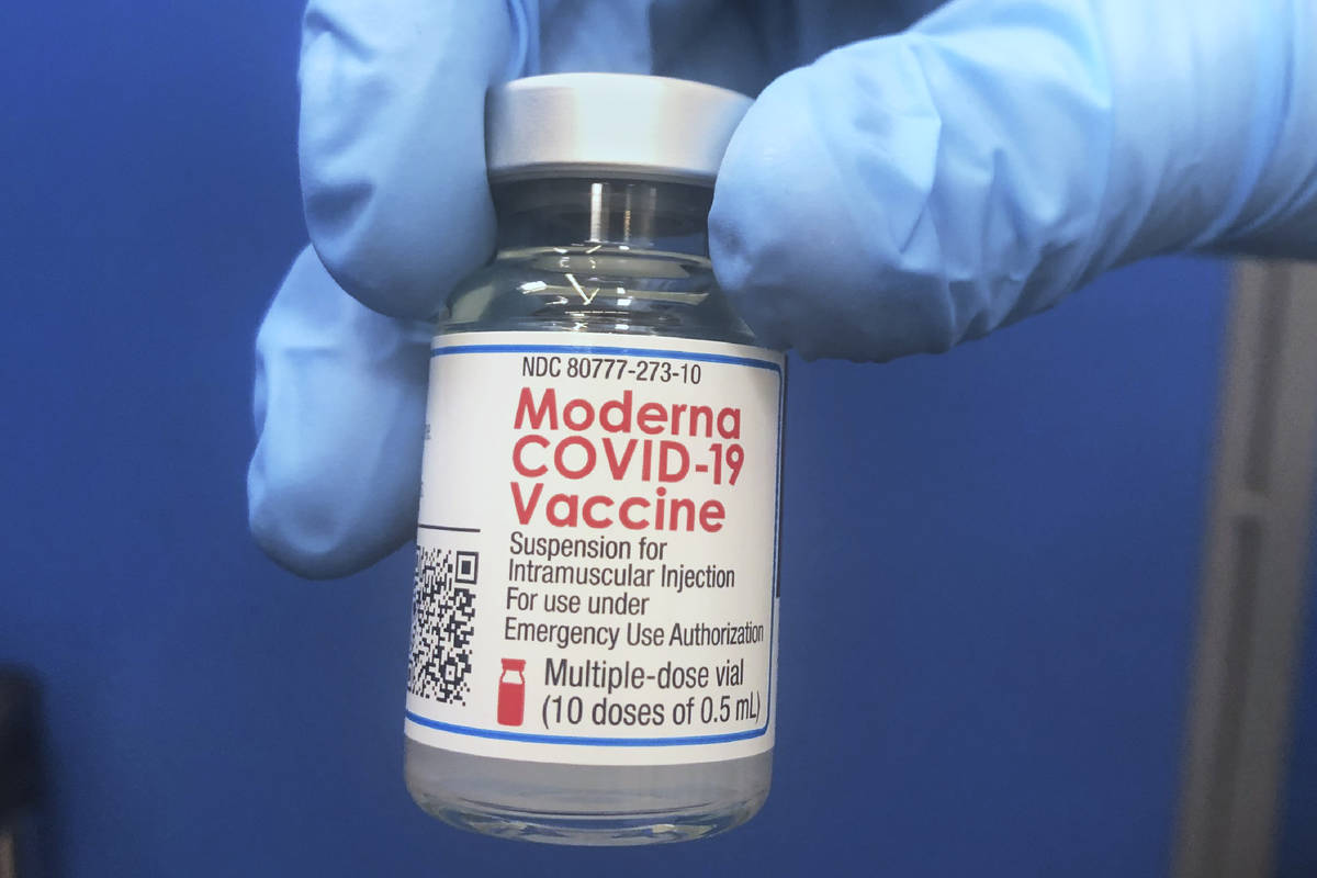 A vial of Moderna COVID-19 vaccine is held at a vaccination site Friday, Feb. 19, 2021, in Okla ...