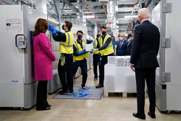 President Joe Biden, right, and Michigan Gov. Gretchen Whitmer, left, tour a Pfizer manufacturi ...