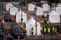 Motorists wait to get their COVID-19 vaccine at a federally-run vaccination site set up on the ...