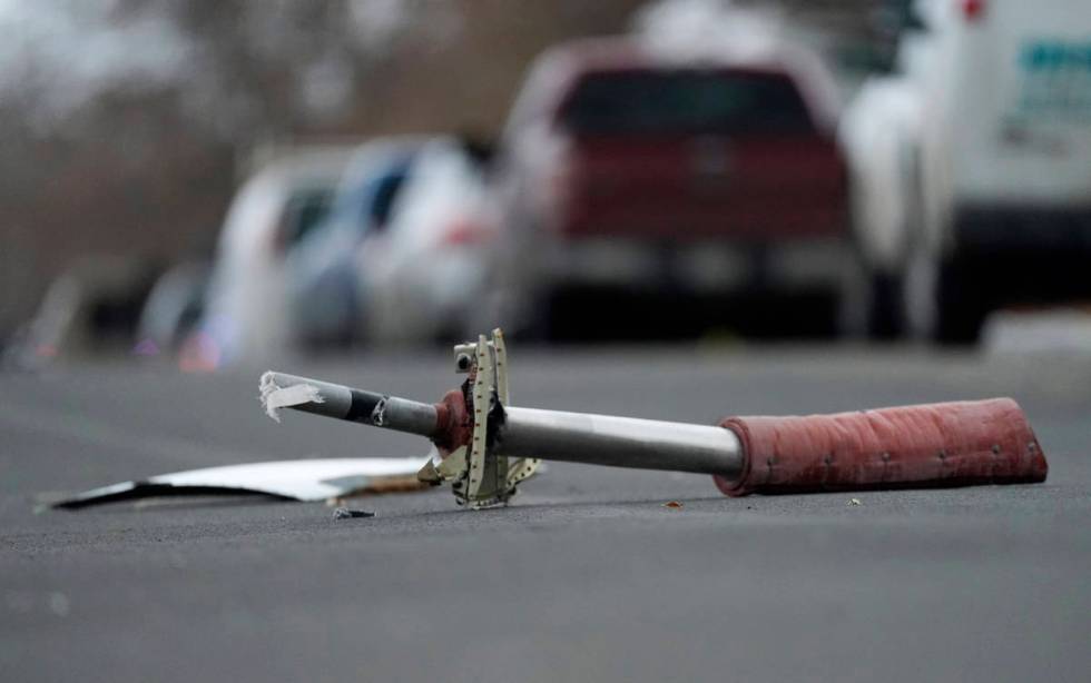 A part from a United Airlines jetliner sits in the middle of Elmwood Street in the street near ...