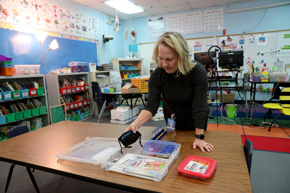 Kindergarten teacher Suzy Huffer prepares a student box including personal face mask at McDonie ...