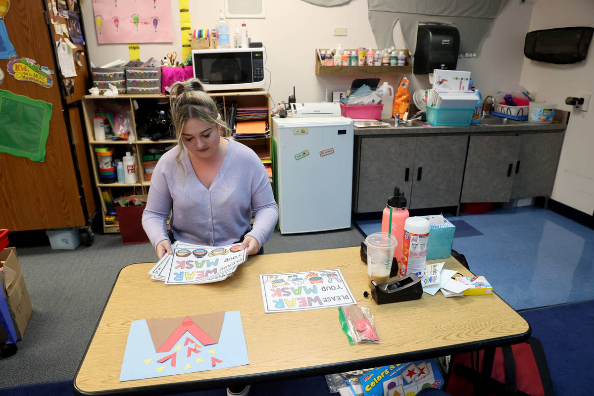 Whitney Huffer, a specialized program teaching assistant, prepares the special needs classroom ...