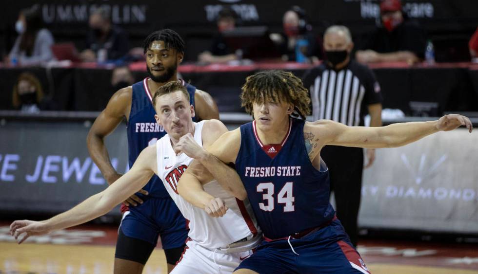 UNLV Rebels forward Moses Wood (1) fights for a loose ball with Fresno State Bulldogs center Br ...