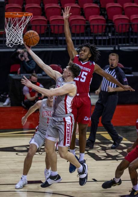 UNLV Rebels guard Caleb Grill (3) beats Fresno State Bulldogs guard Anthony Holland (25) to the ...