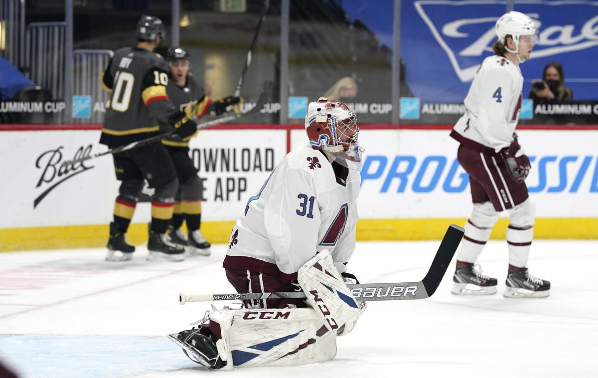 Colorado Avalanche goaltender Philipp Grubauer, front, reacts after giving up a goal to Vegas G ...