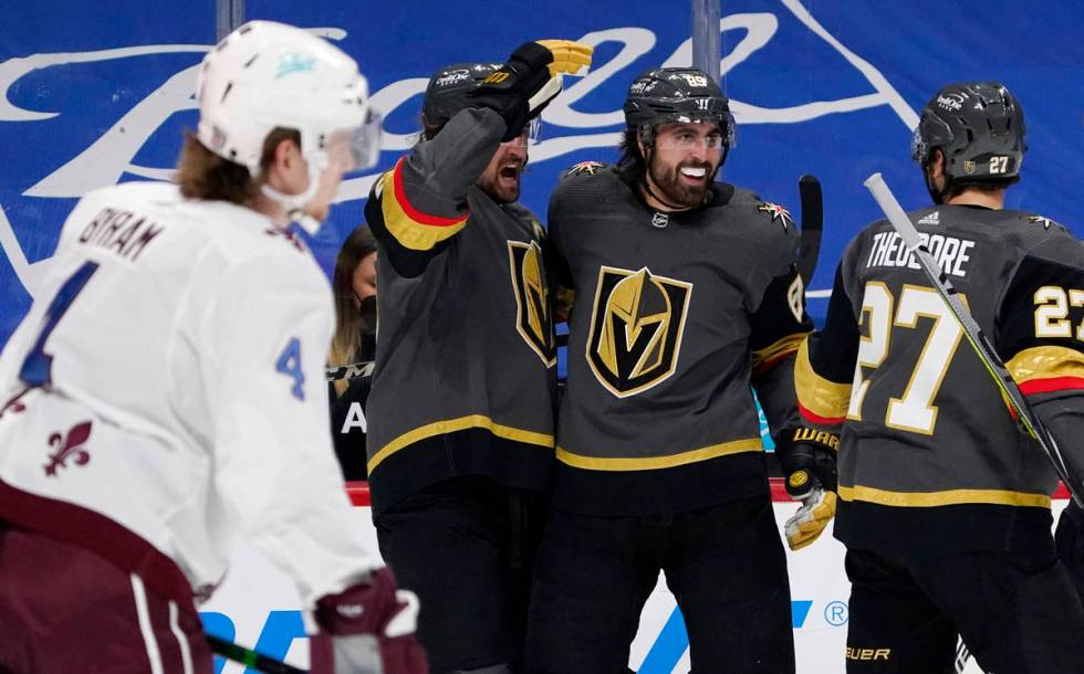 Vegas Golden Knights right wing Alex Tuch, back center, celebrates his goal with right wing Mar ...
