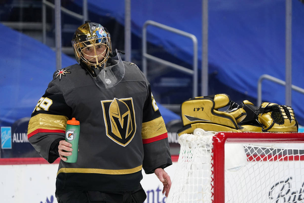 Vegas Golden Knights goaltender Marc-Andre Fleury takes off his gloves and rests them on the to ...