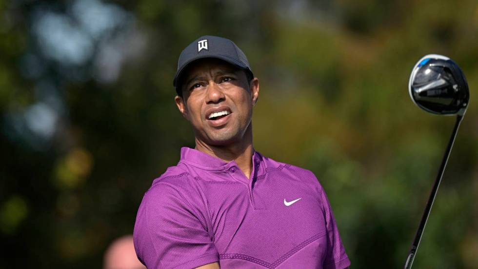 This Dec. 19, 2020, file photo shows Tiger Woods watching his tee shot on the first hole during ...