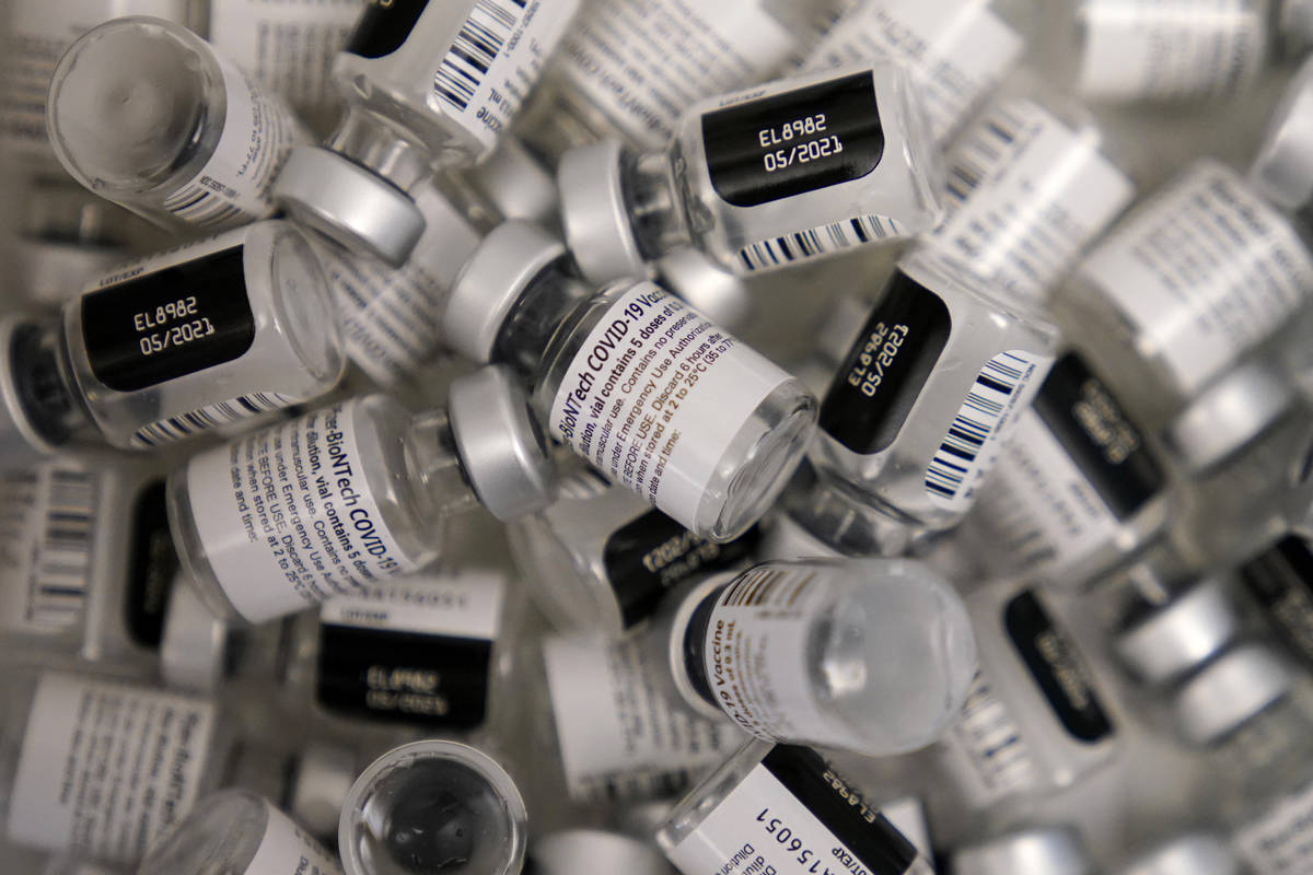 FILE - In this Friday, Jan. 22, 2021, file photo, empty vials of the Pfizer-BioNTech COVID-19 v ...