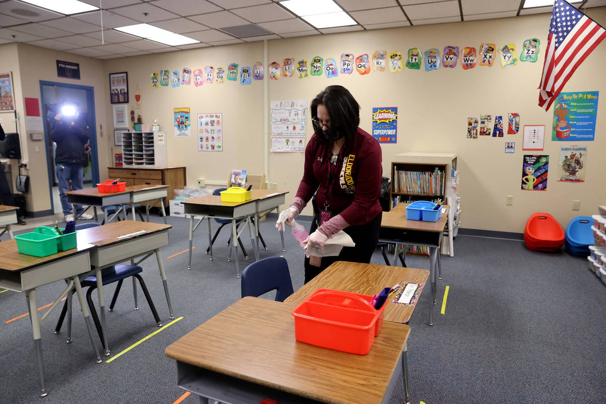 Clark County School District Support Staff Trainer Tia Baker sanitizes a classroom at Eisenberg ...