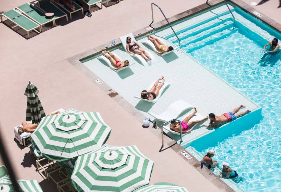 Hotel guests relax by the pool at Park MGM as temperatures reach 100 degrees in the Las Vegas V ...