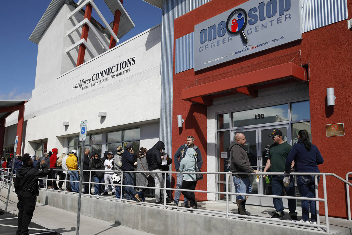 In this March 17, 2020, file photo, people wait in line for help with unemployment benefits at ...