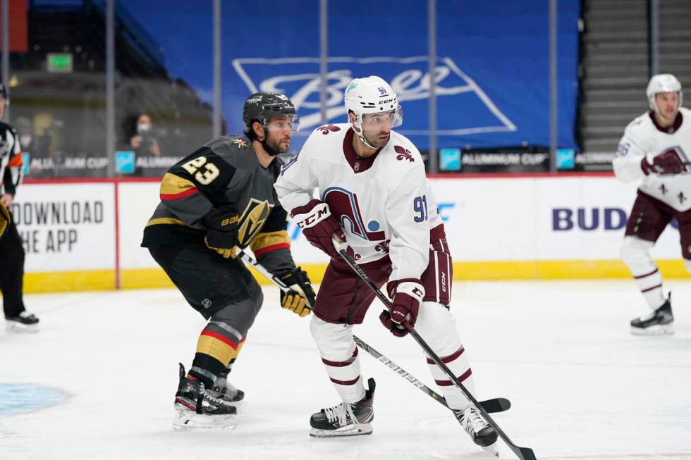 Colorado Avalanche center Nazem Kadri (91) and Vegas Golden Knights defenseman Alec Martinez (2 ...