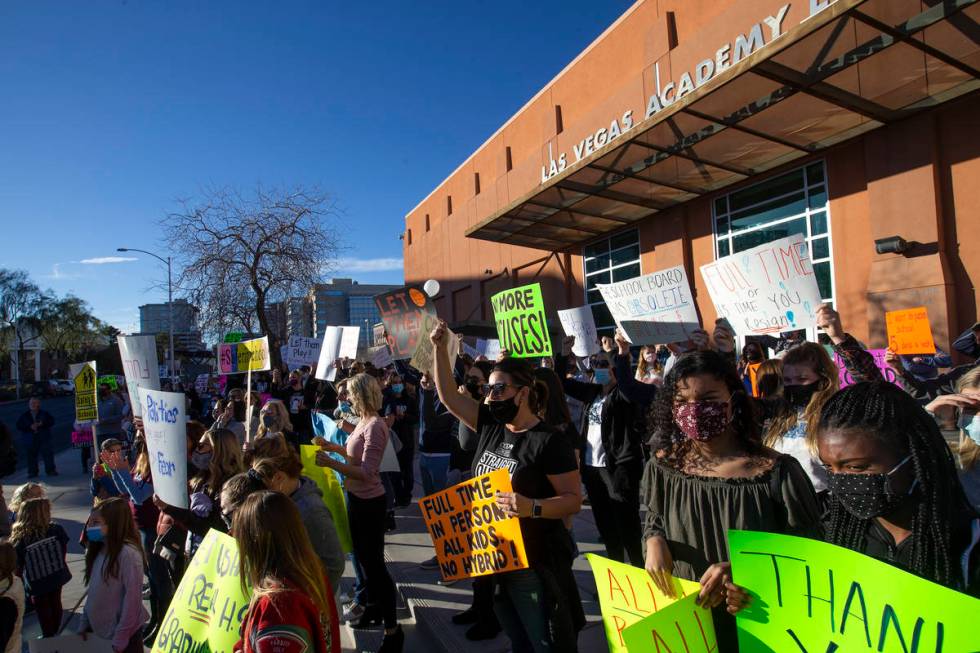 A group of parents, students and folks who want kids back in school protest before outside Las ...