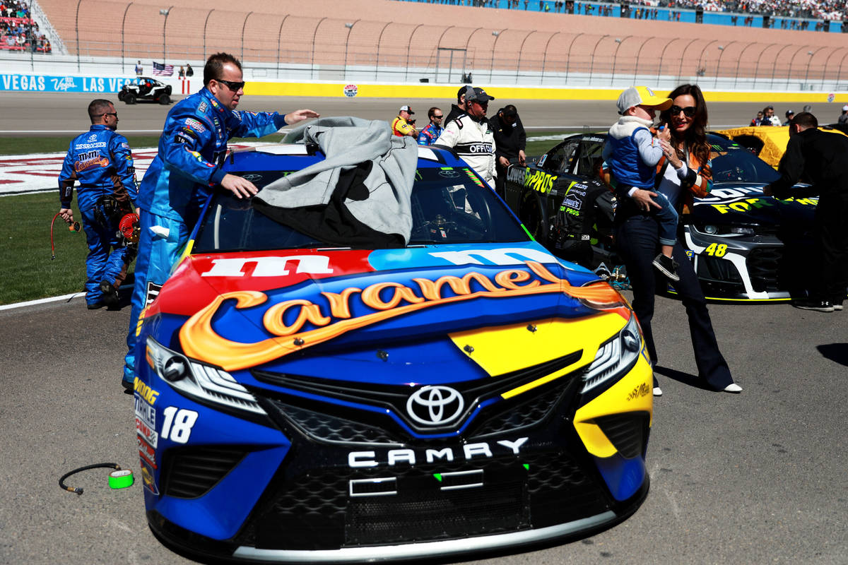 Samantha Busch and her son, Brexton, by Kyle Busch's car ahead of the Monster Energy NASCAR Cup ...