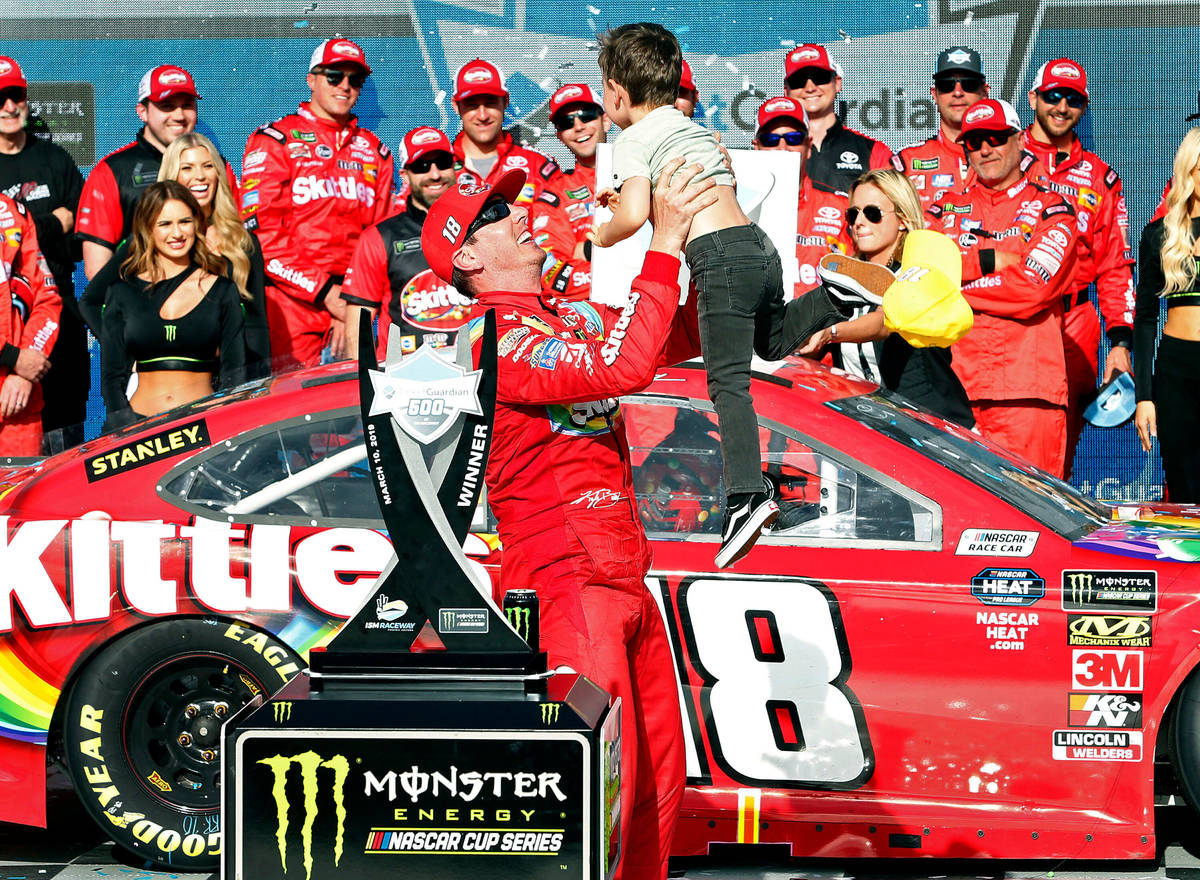 Kyle Busch tosses his son Brexton in the air after winning the NASCAR Cup Series auto race at I ...