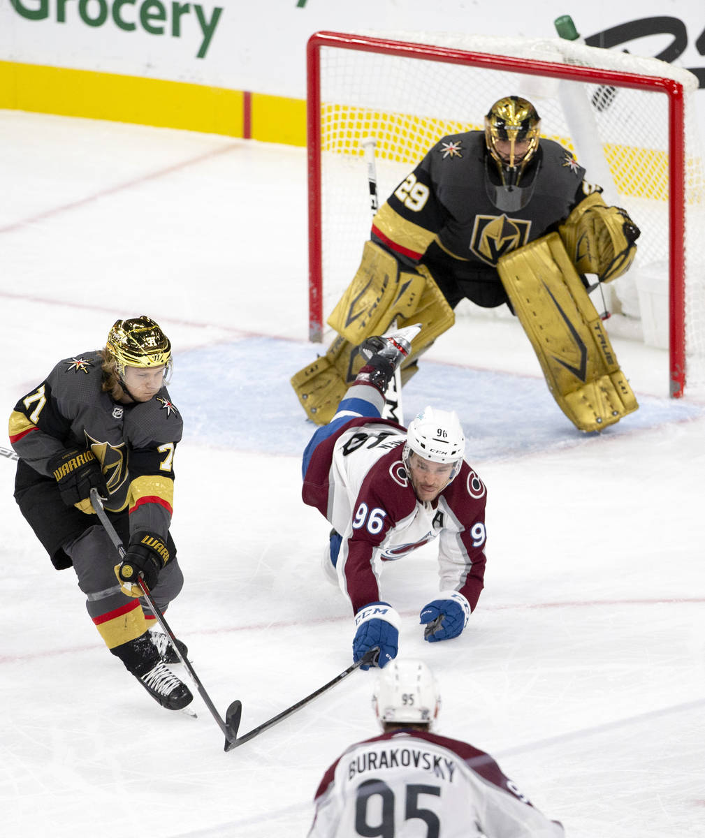 Golden Knights center William Karlsson (71) reaches while Colorado Avalanche right wing Mikko R ...