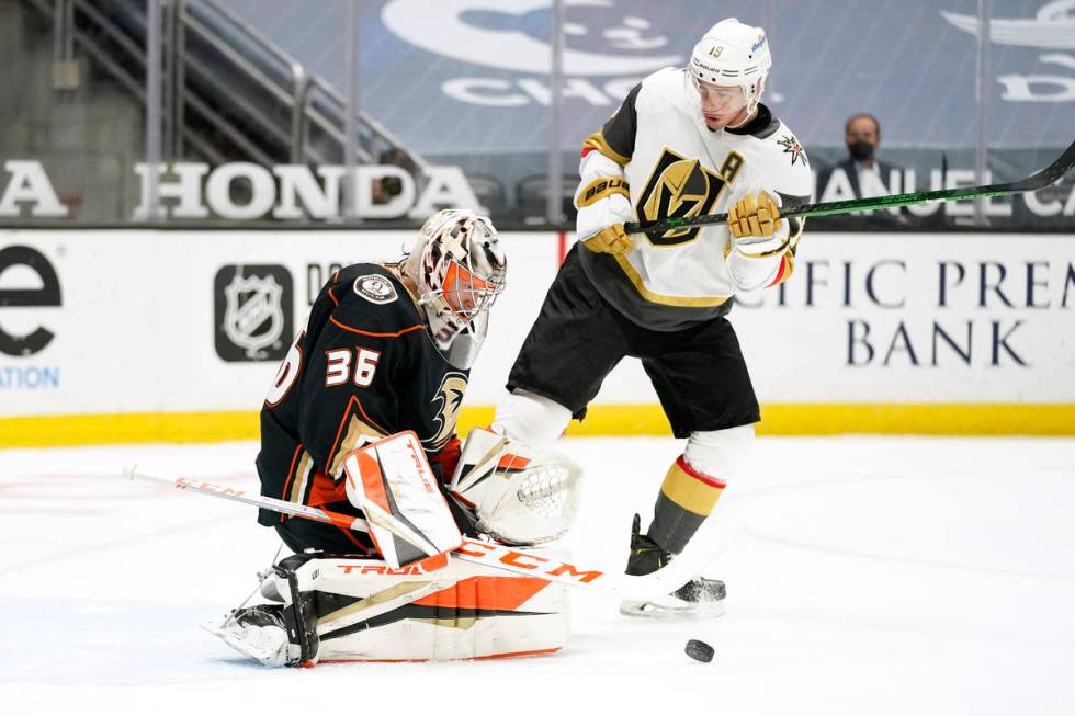 Anaheim Ducks goaltender John Gibson, left, deflects a shot as Vegas Golden Knights right wing ...
