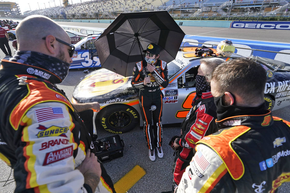 Noah Gragson, center, talks with his crew before the start of a NASCAR Xfinity Series auto race ...