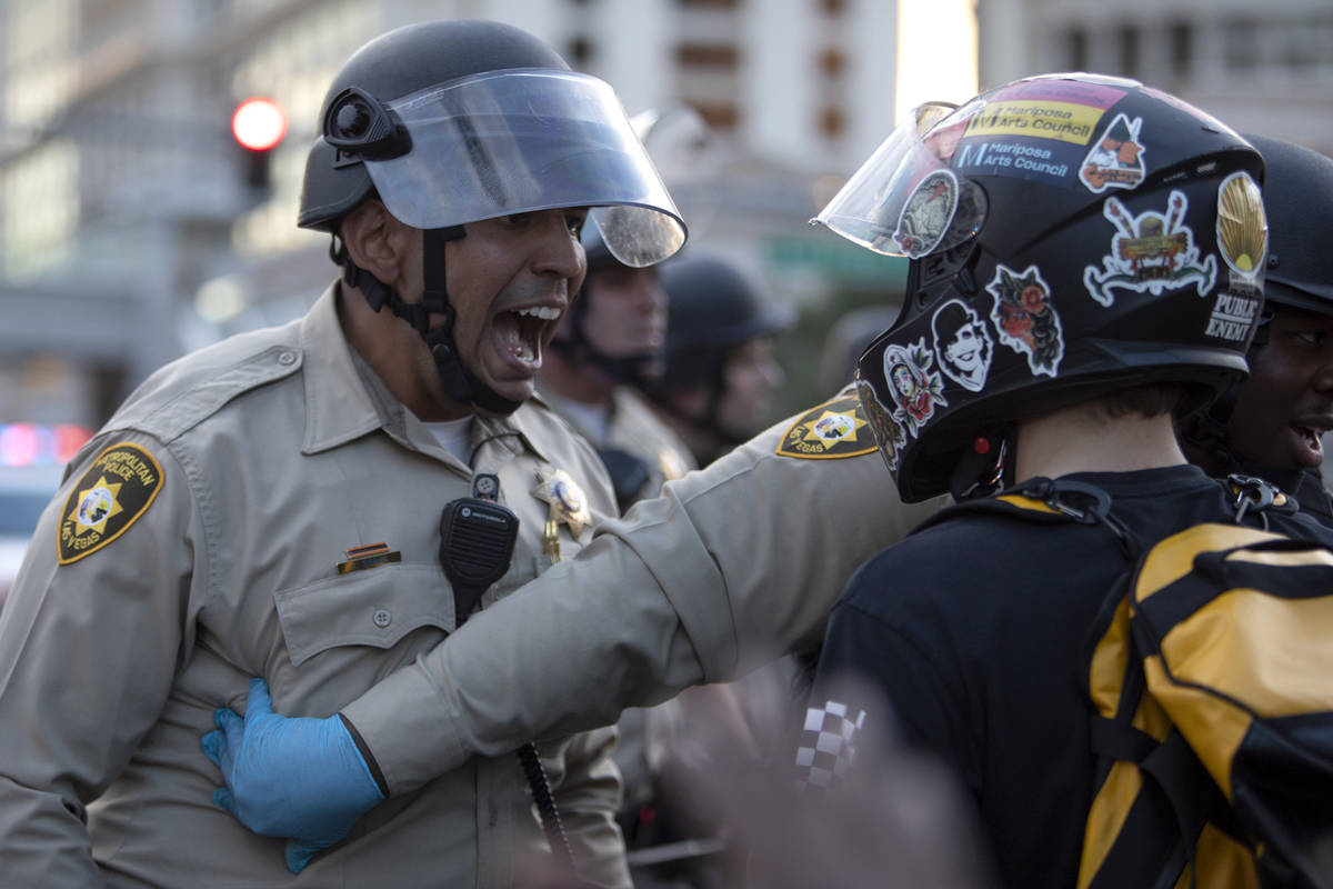 A Las Vegas police officer shouts at a protester to back up as tension between police and demon ...