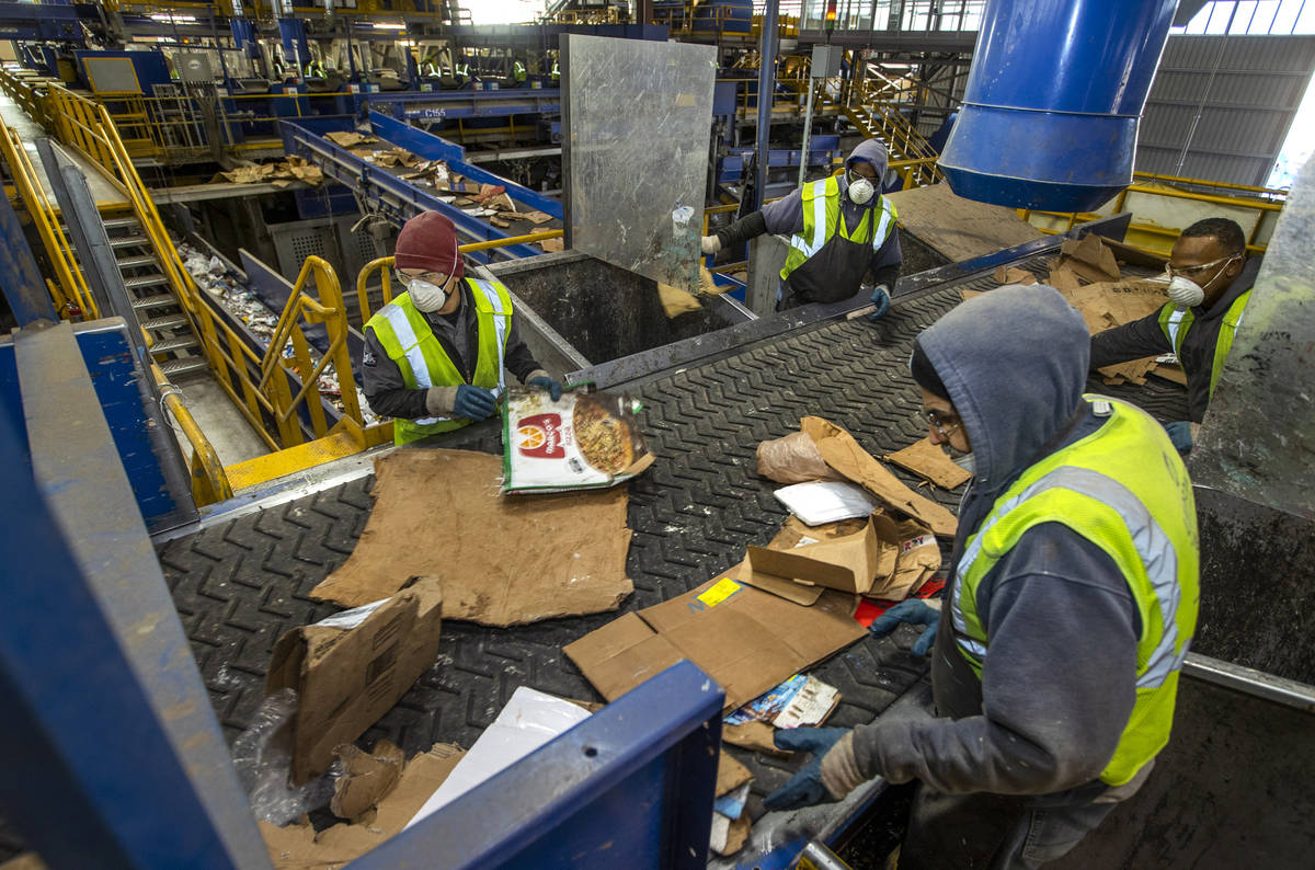 Workers sort cardboard and other fibers at the Republic Services recycling center on Jan. 15, 2 ...