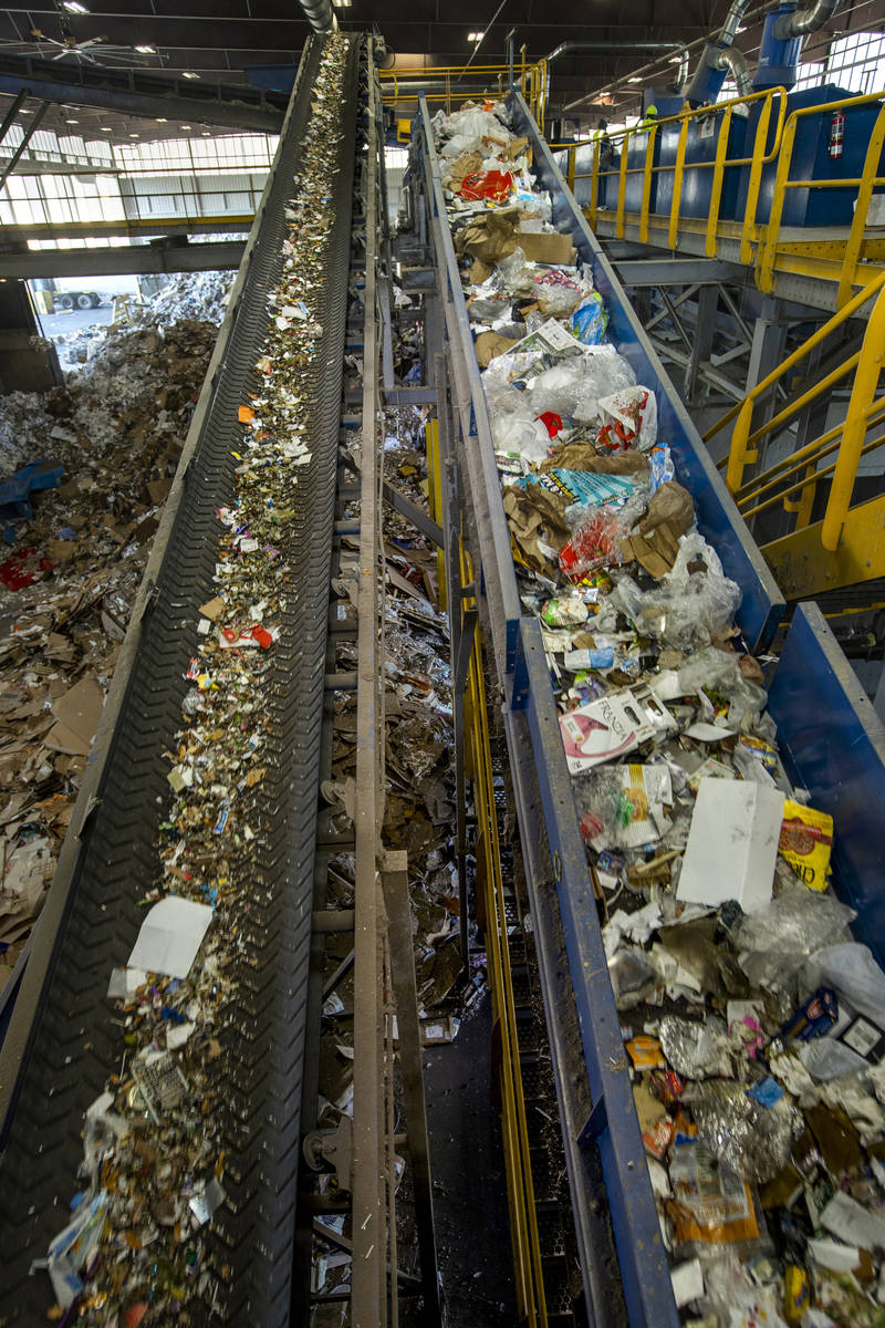 Glass, left, is sorted and moved by conveyor belt to a glass cleanup system with other material ...