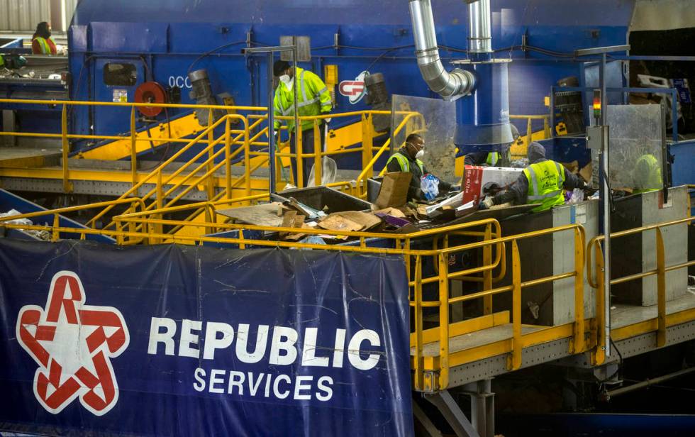 Workers sort cardboard and other fibers at the Republic Services recycling center on Jan. 15, 2 ...