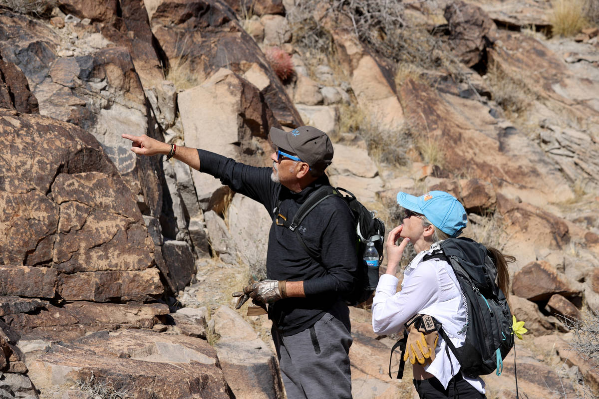 Guido and Wendy Metzger of Henderson check out rock art on the Petroglyph Trail in Sloan Canyon ...