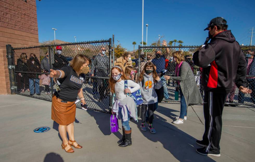 Vice principal Magdalena Casillas, from left, helps direct students through a side gate at Gool ...