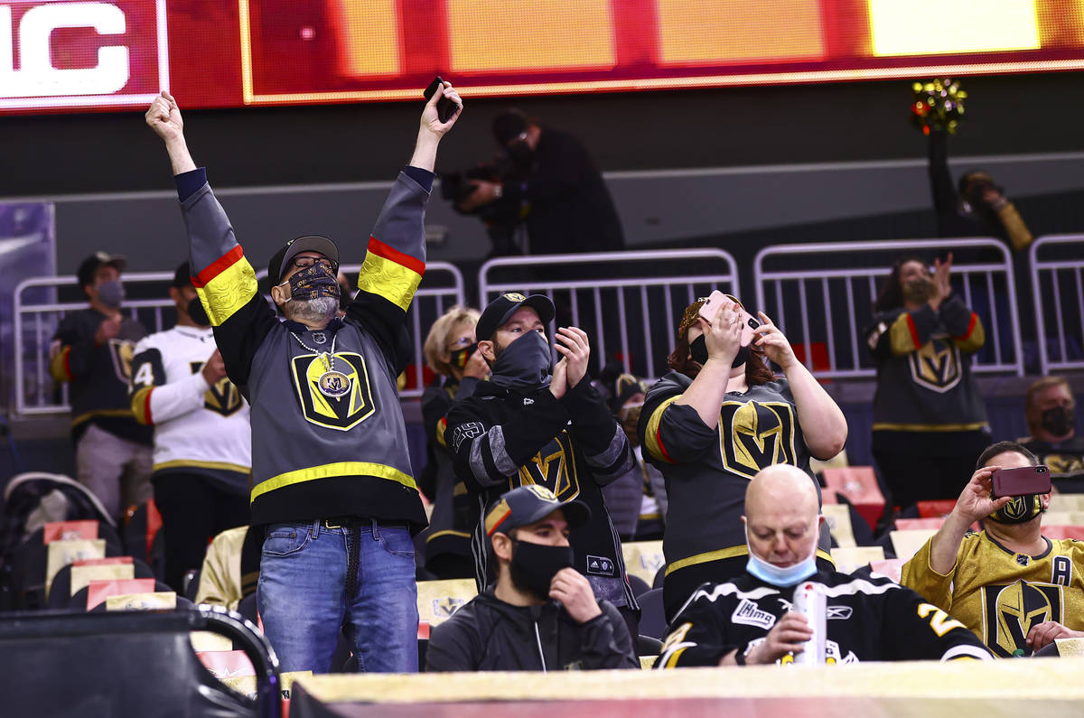 Golden Knights fans cheer as players warm up before taking on the Minnesota Wild in an NHL hock ...