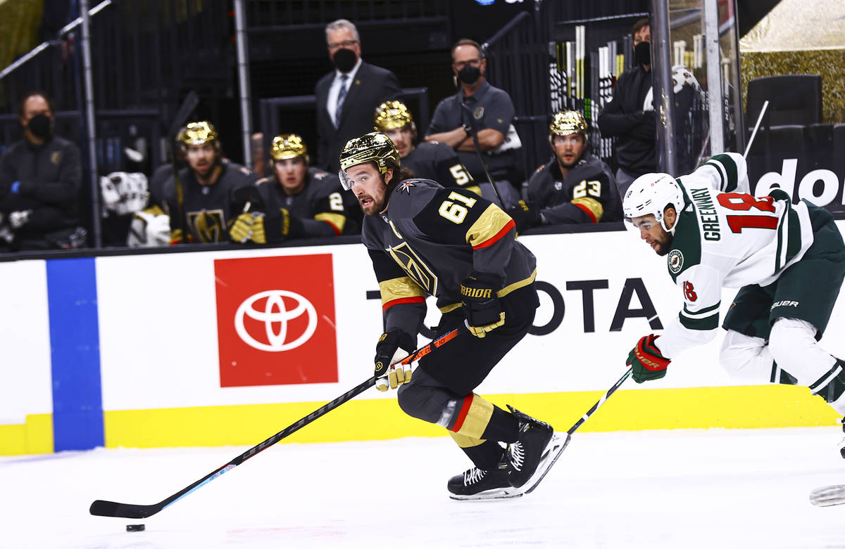 Golden Knights right wing Mark Stone (61) skates with the puck past Minnesota Wild left wing Jo ...
