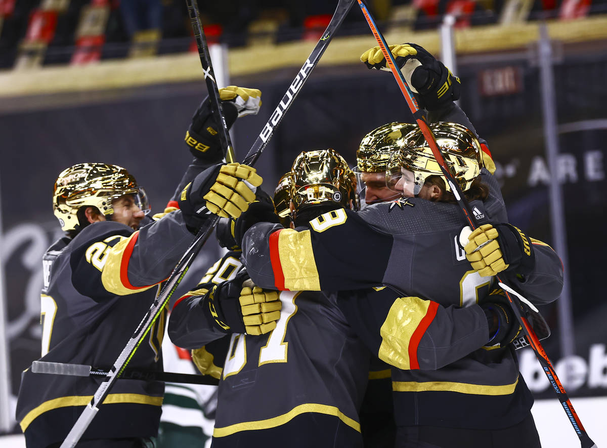 Golden Knights players celebrate a goal by Max Pacioretty during the second period of an NHL ho ...
