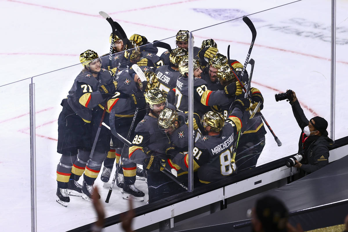 Golden Knights players celebrate their overtime win against the Minnesota Wild in an NHL hockey ...