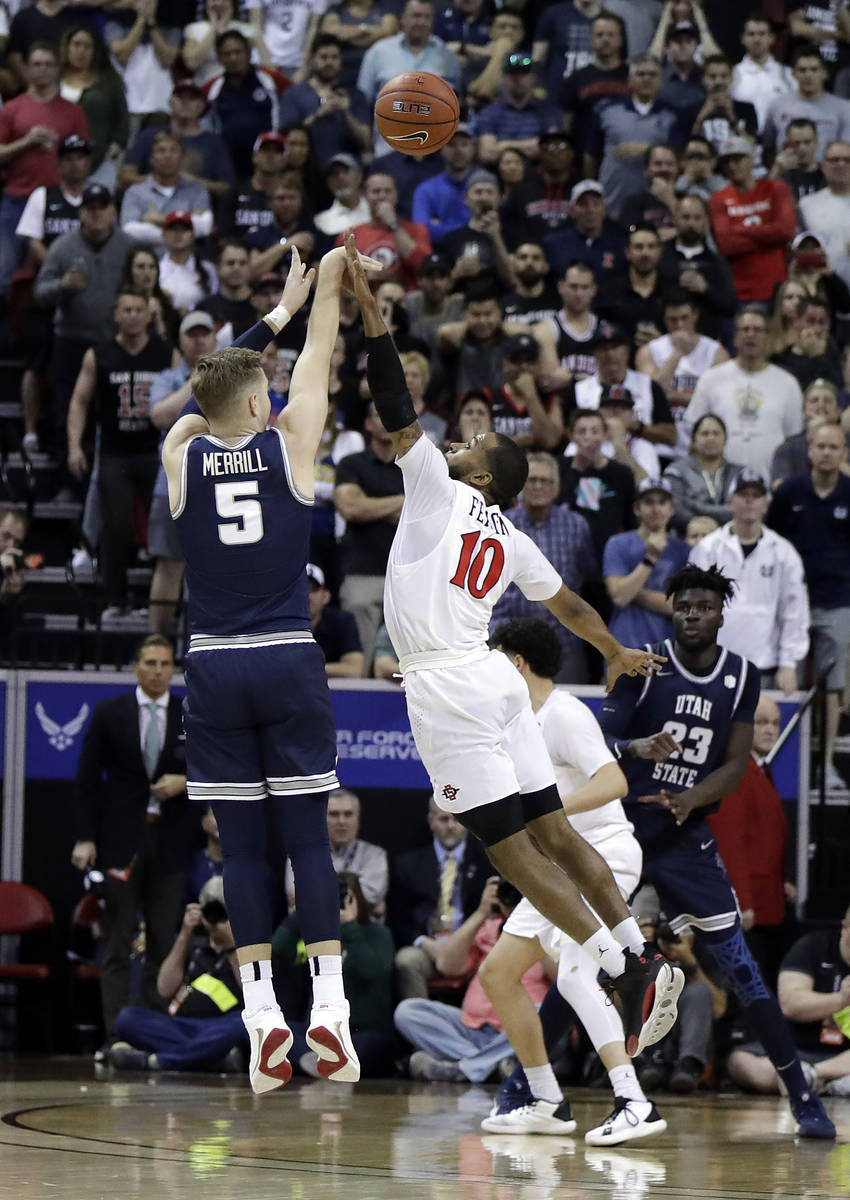 Utah State's Sam Merrill (5) sinks a 3-point shot as San Diego State's KJ Feagin defends during ...
