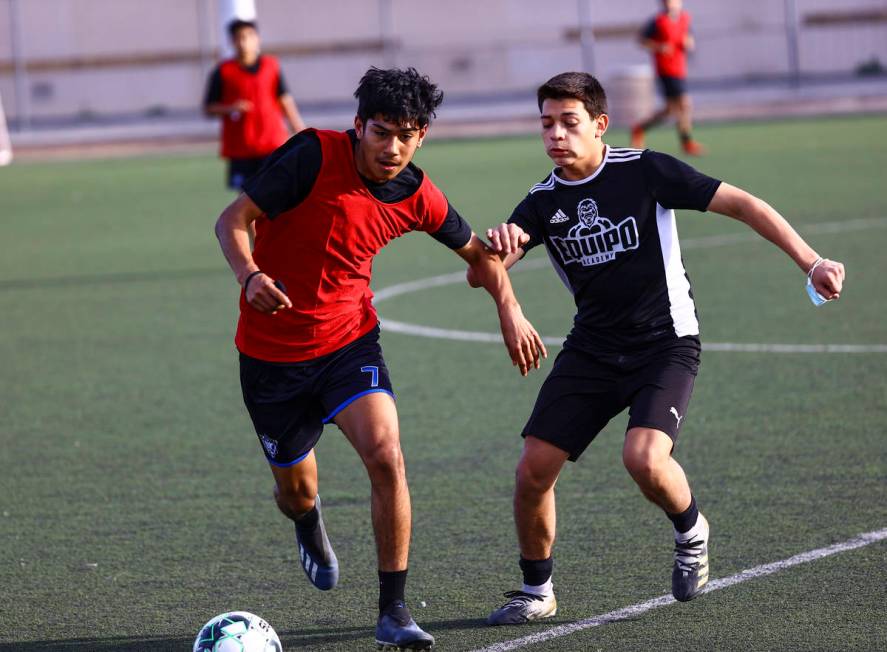 Equipo Academy's Valentin Ruiz, left, and Hanzel Padilla battle for the ball during soccer prac ...