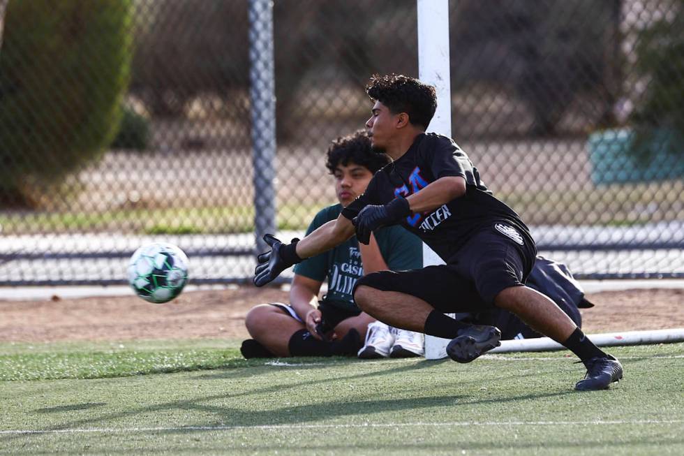 Equipo Academy goalkeeper Roberto Santana dives for the ball during soccer practice at Mike Mor ...