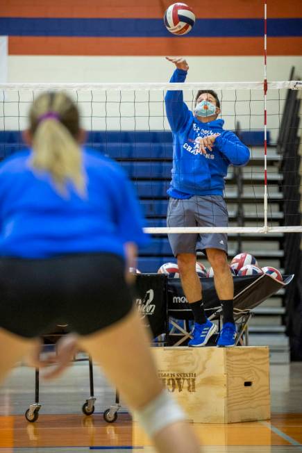 Varsity girls volleyball coach Gregg Nunley serves a ball to players during practice at Bishop ...