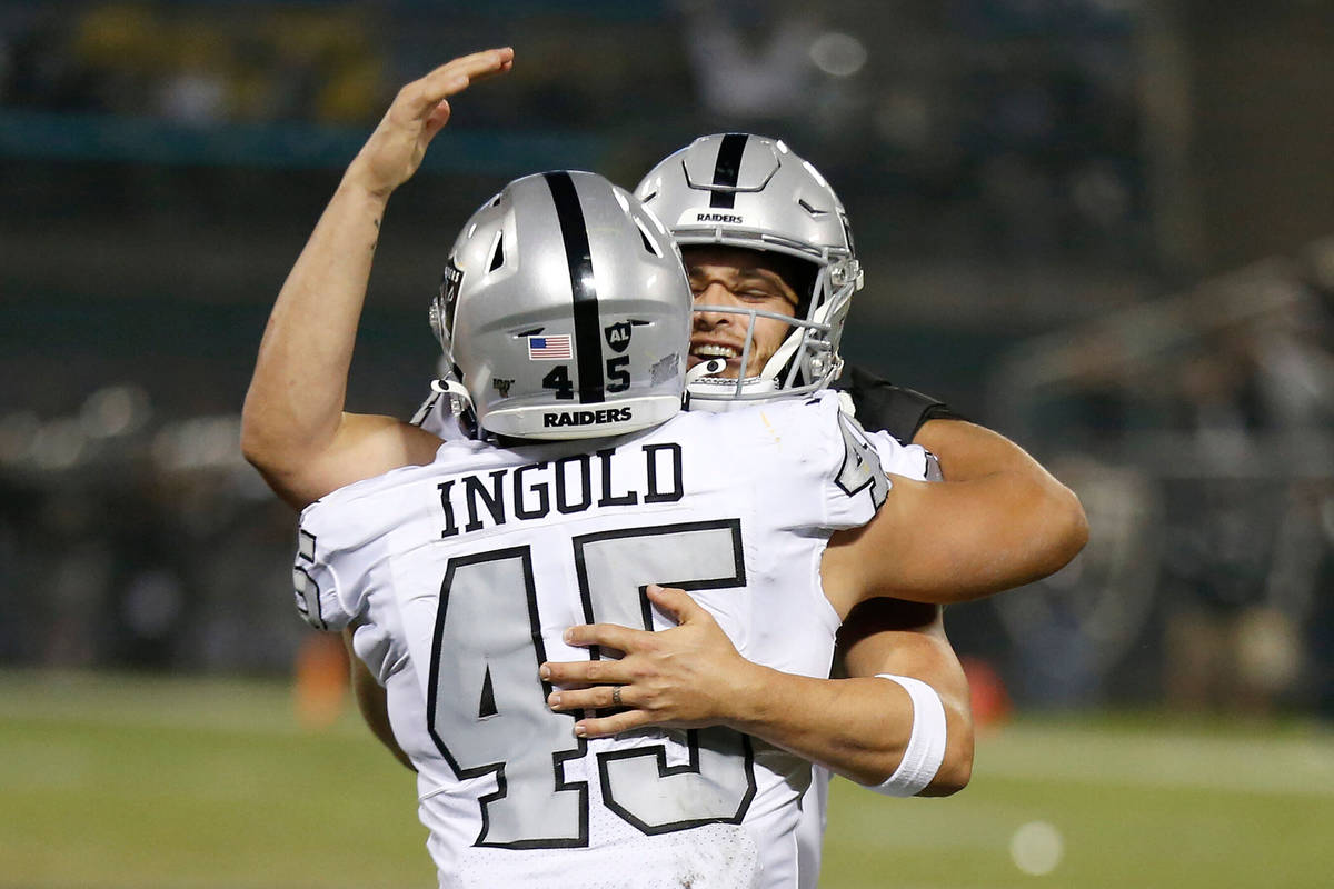 Oakland Raiders running back Alec Ingold (45) celebrates with quarterback Derek Carr after they ...