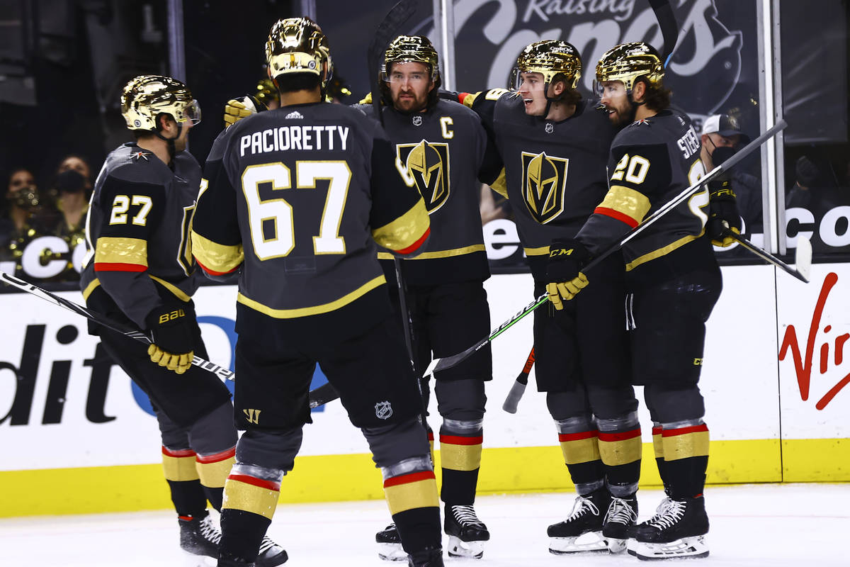 Golden Knights center Cody Glass, fourth from left, celebrates his goal against the Minnesota W ...